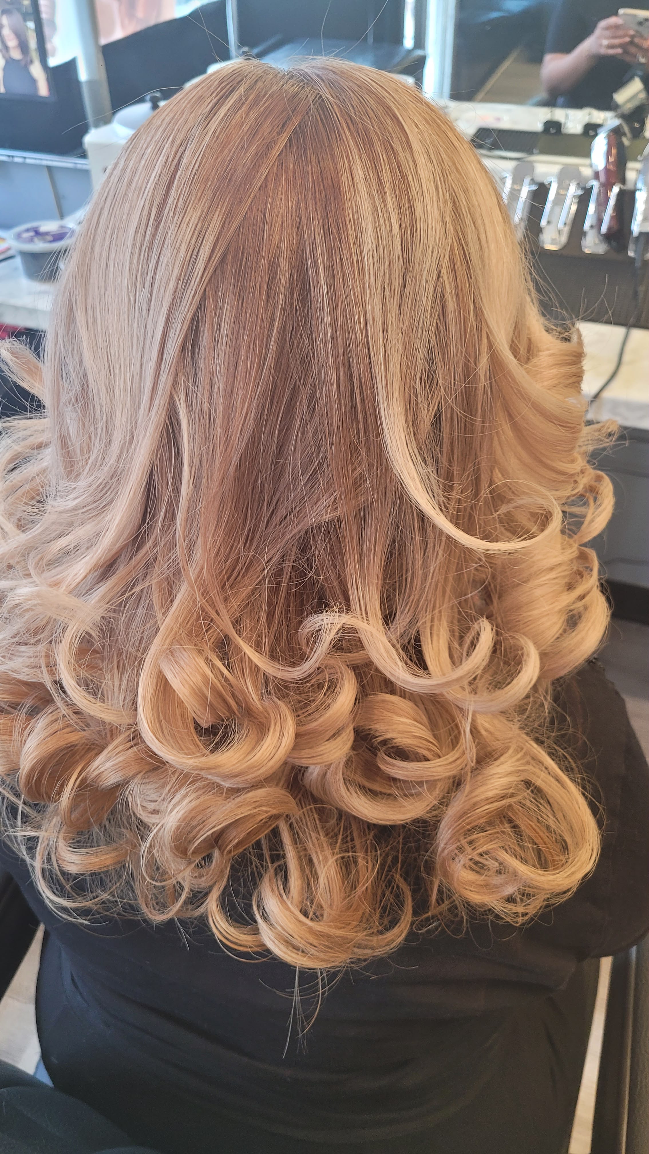 Warm blonde balayage with a polished blowout